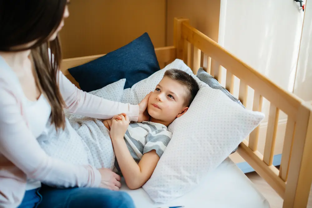 A mother takes care of her child who has a fever and fever. Disease and healthcare