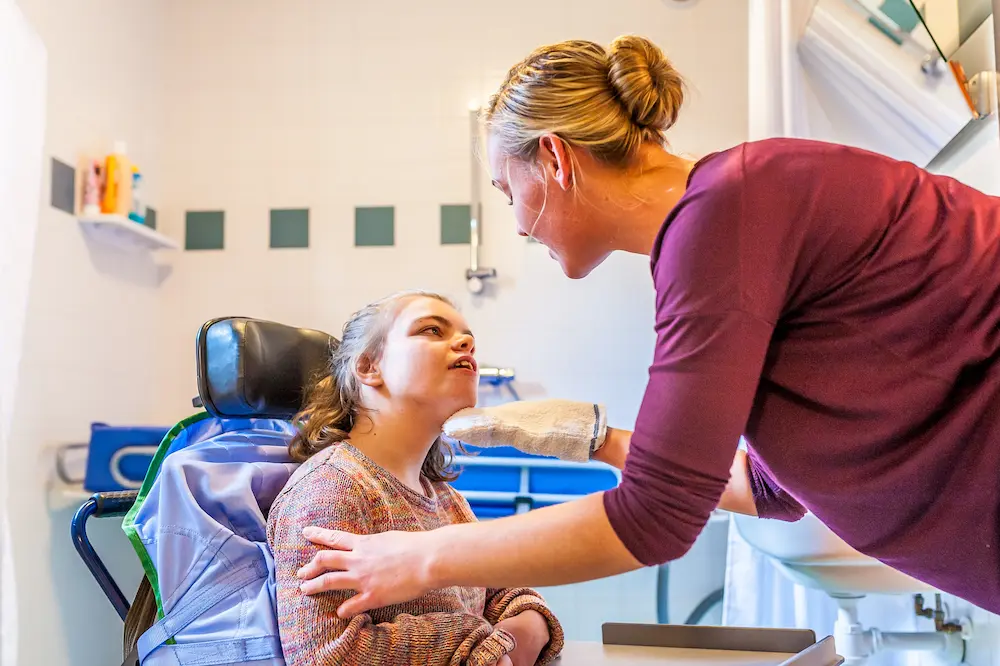 Disability a disabled child being cared for by a nurse / Disability a disabled child in a wheelchair being cared for by a nurse