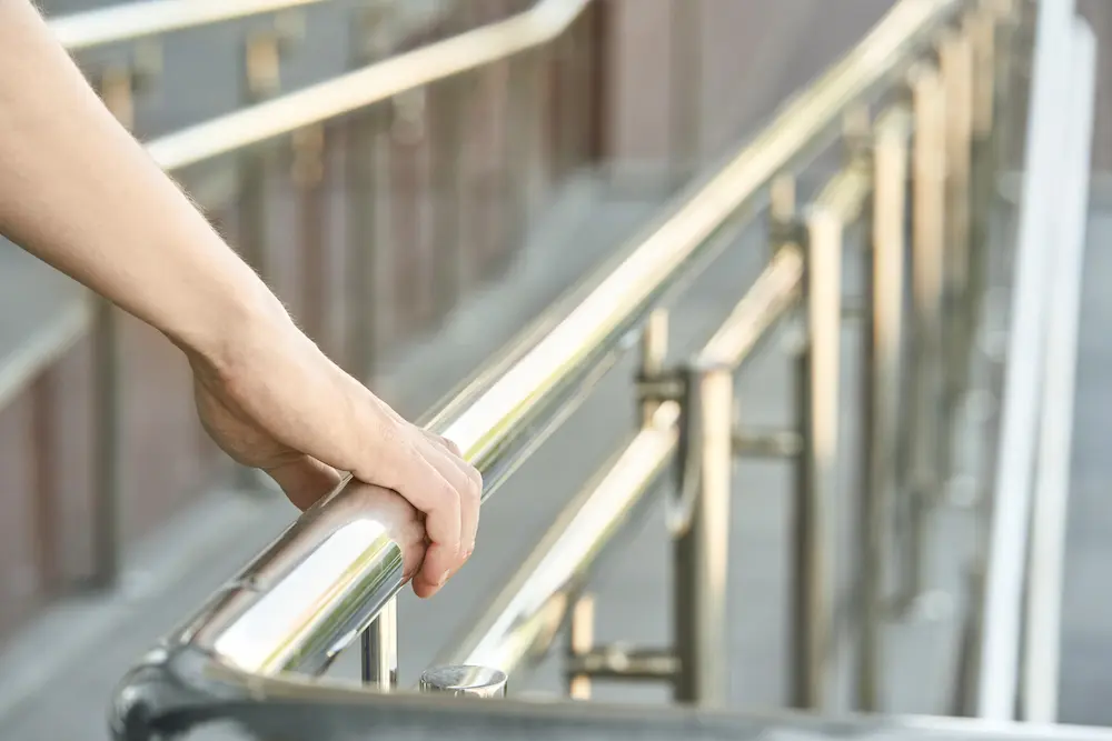 Hand using handrail for wheelchair. Man support.