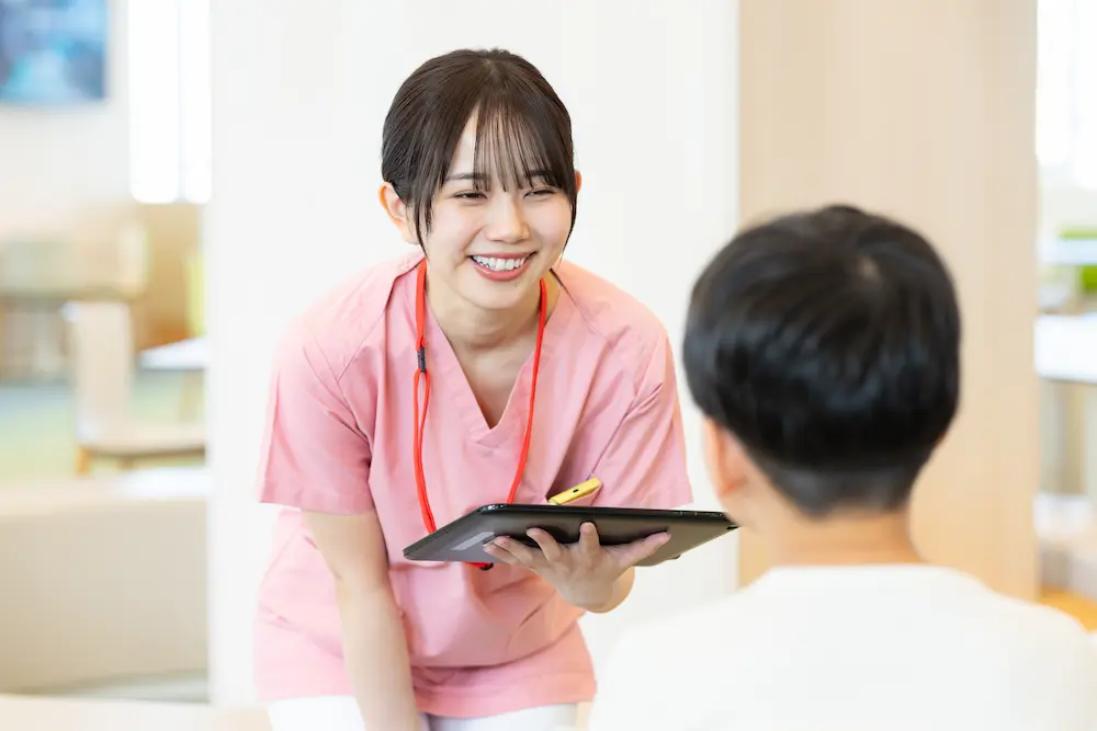 Medical personnel holding a tablet