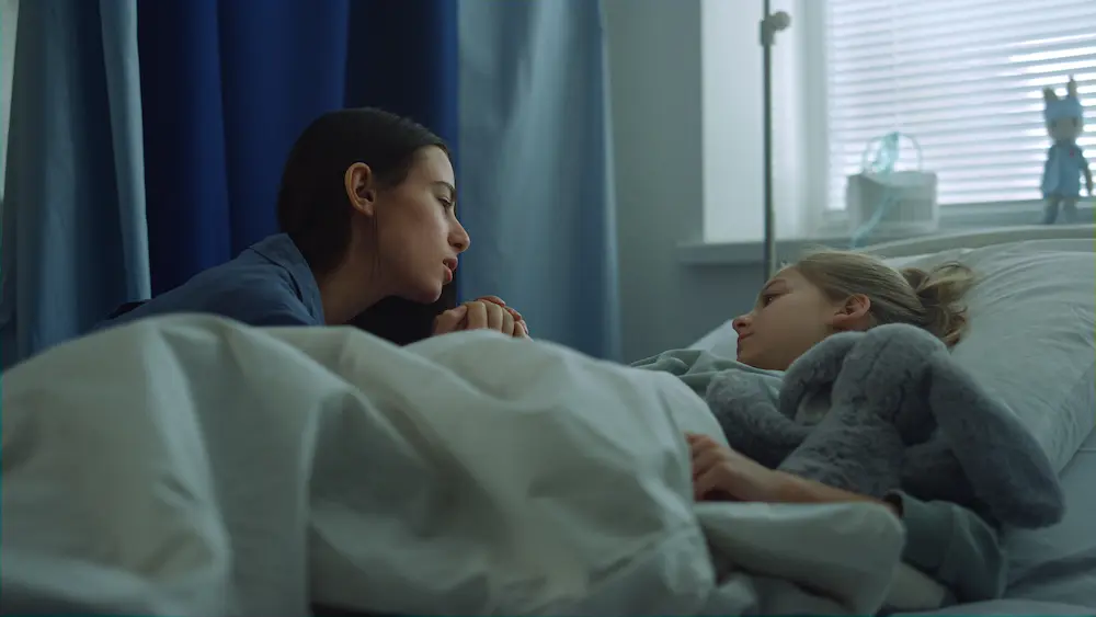 Mother visit daughter ward holding hand. Supportive parent comforting sick kid