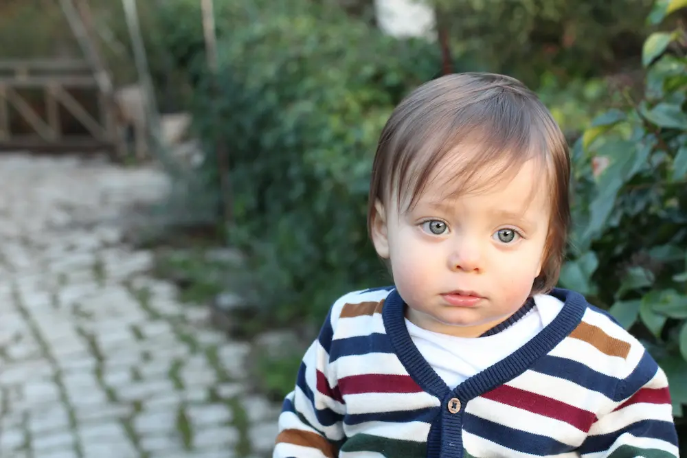 Sad one year old baby outdoors